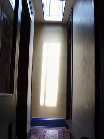 Mirrored skylight bouncing sunlight into the hallway at KentSuites